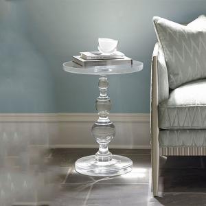 Transparent acrylic round table beside the sofa display